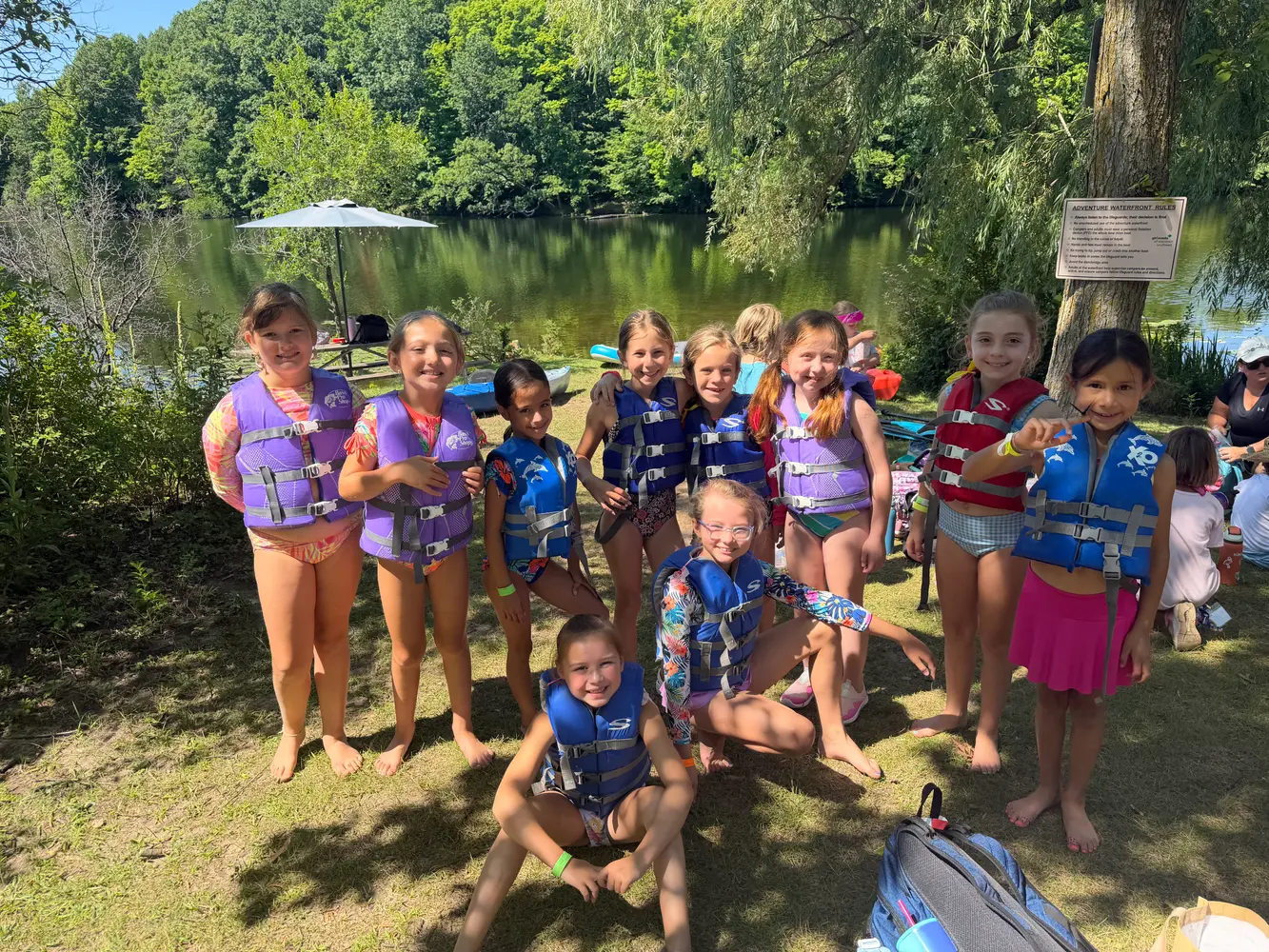 Girl Scouts gathered beside a lake