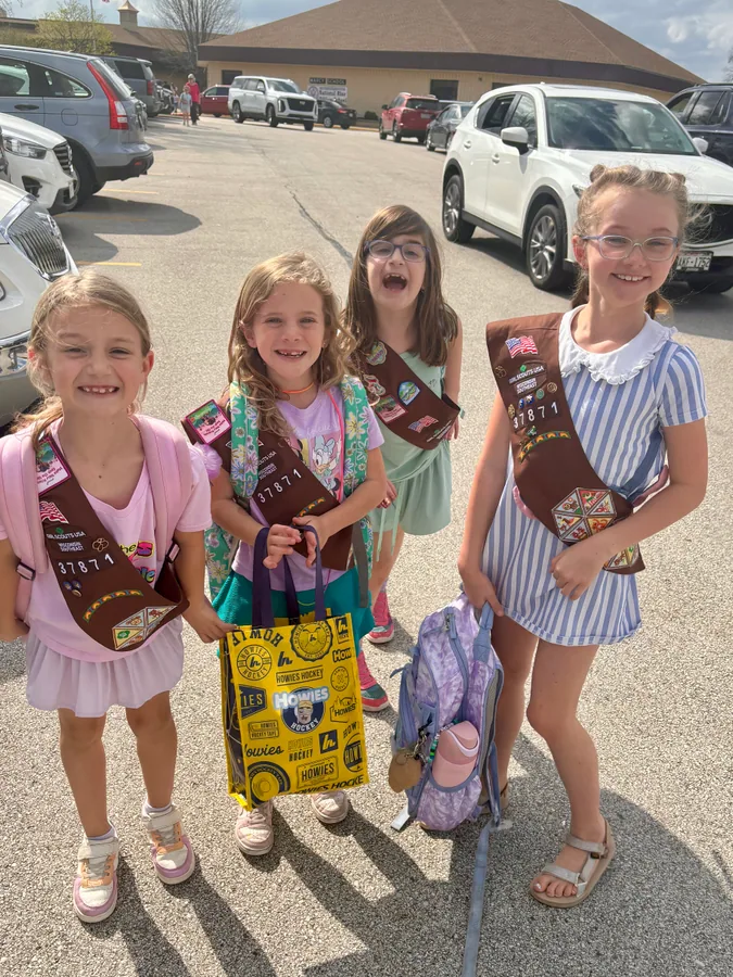 Four Girl Scouts standing together outdoors