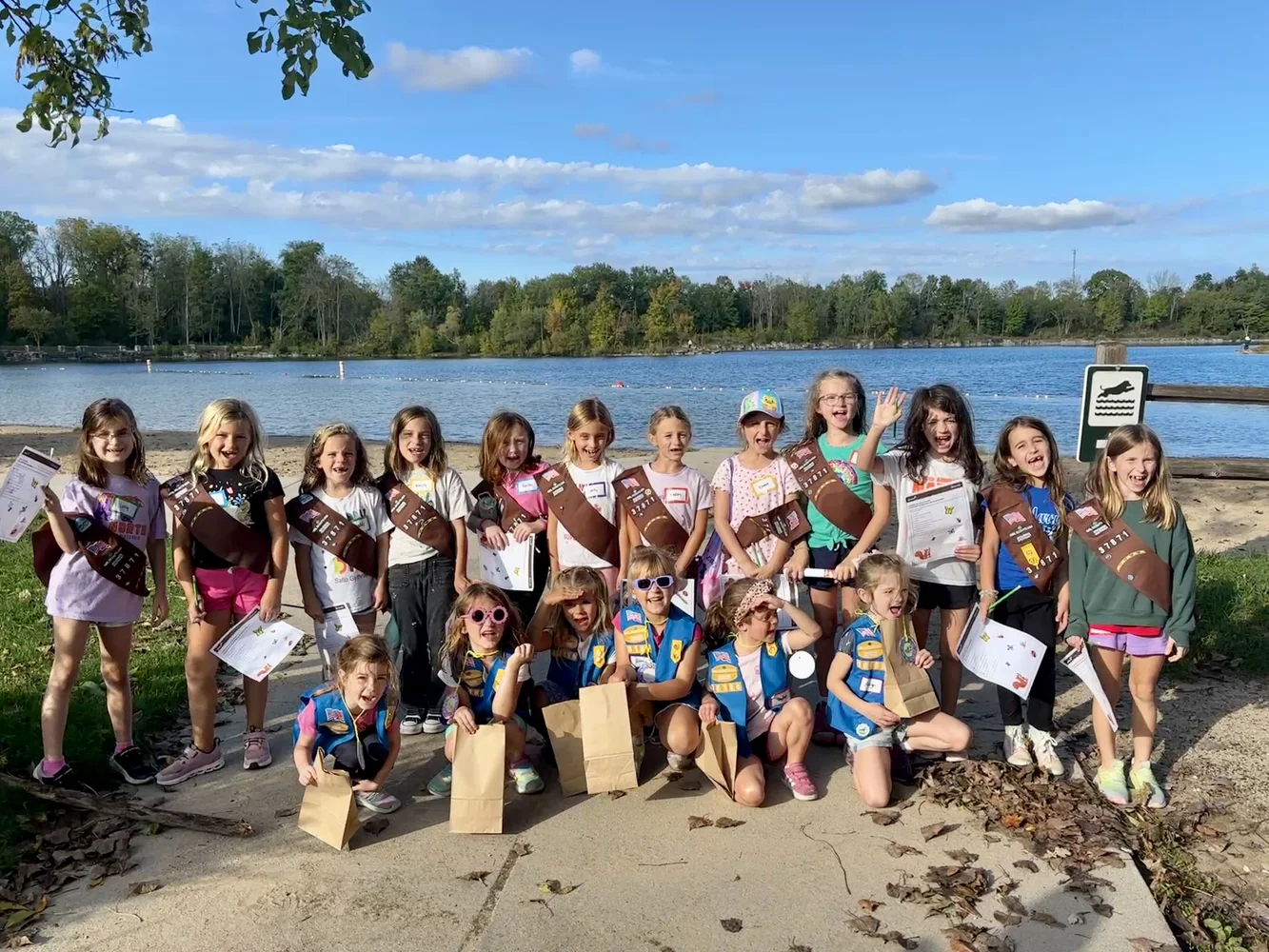 Addie, Ellie, and their Girl Scout troop gathered outdoors